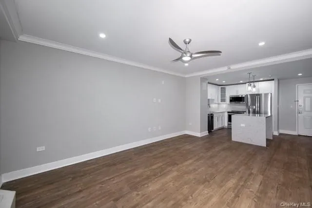 a view of kitchen with wooden floor and a ceiling fan