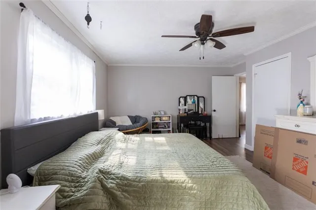 a bed sitting in a bedroom next to a window