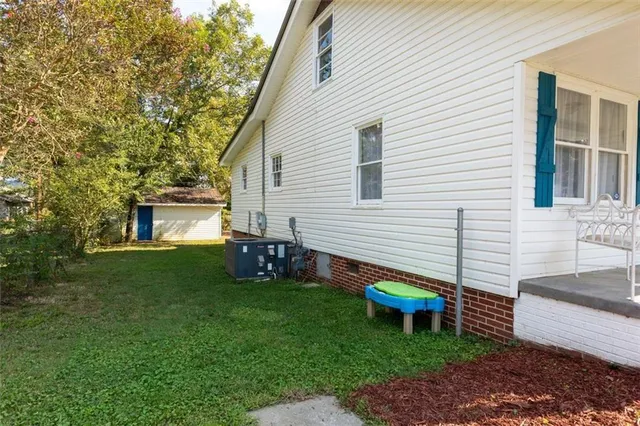 a backyard of a house with table and chairs