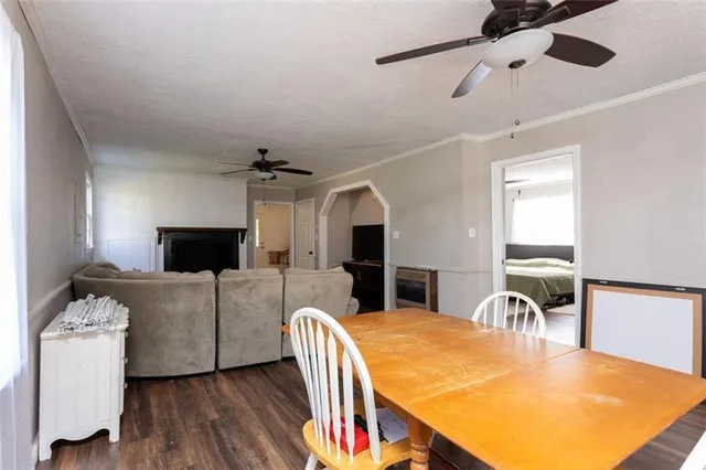 a living room with furniture a flat screen tv and a table