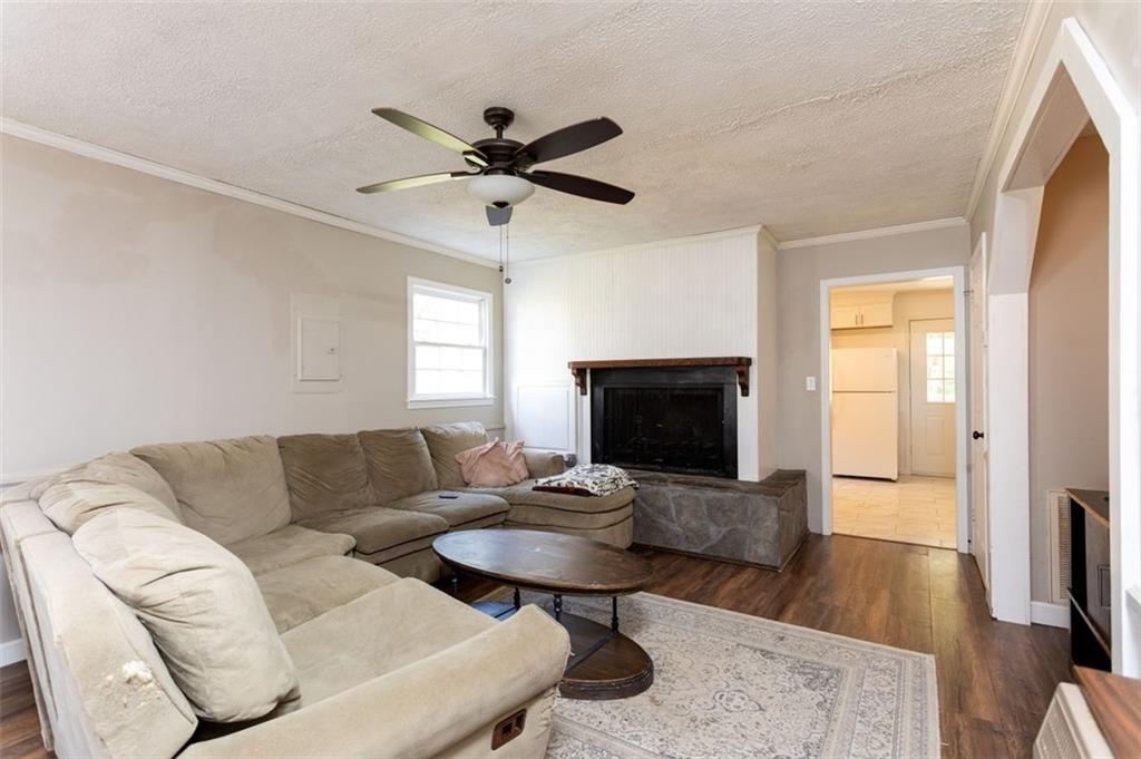 255 East 2nd Street Northeast Rome, GA 30161 - Photo 7 of 25 a living room with furniture a fireplace and a flat screen tv