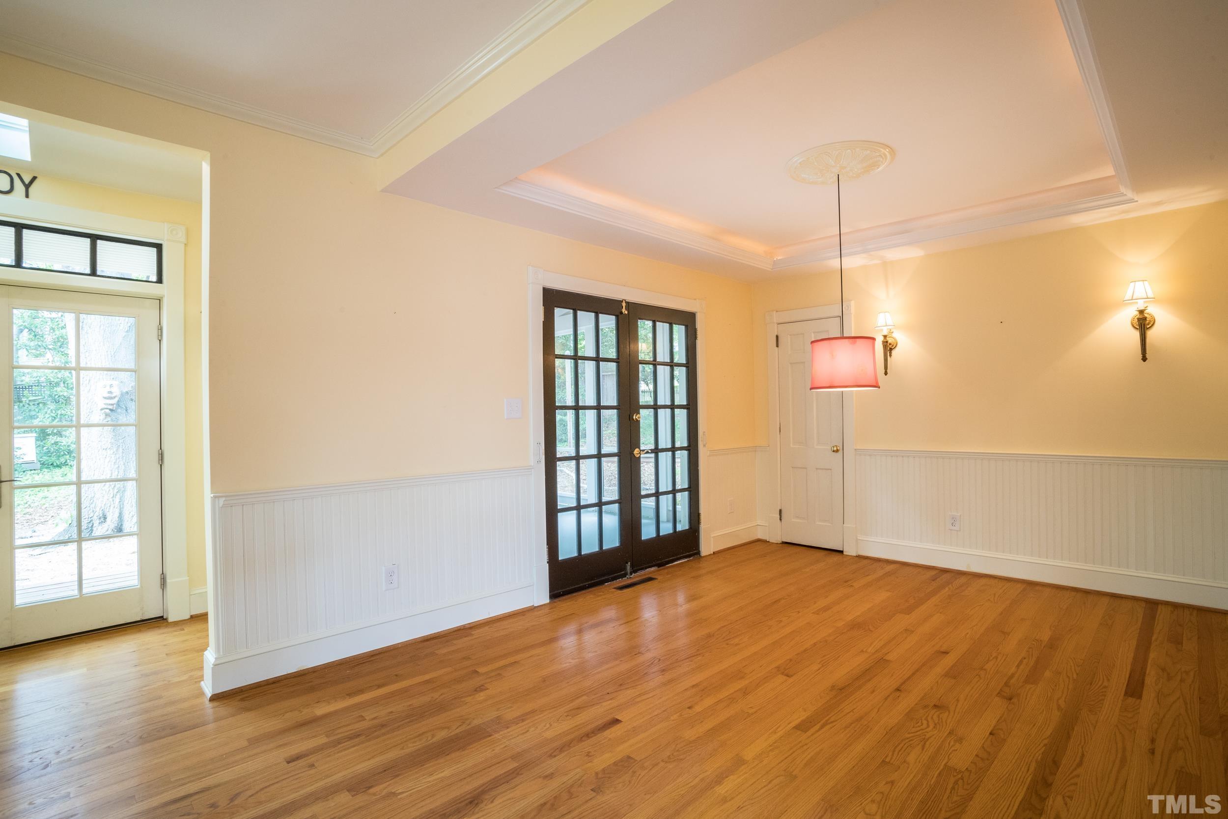 1903 Alexander Road Raleigh, NC 27608 - Photo 11 of 26 an empty room with wooden floor cabinet and windows
