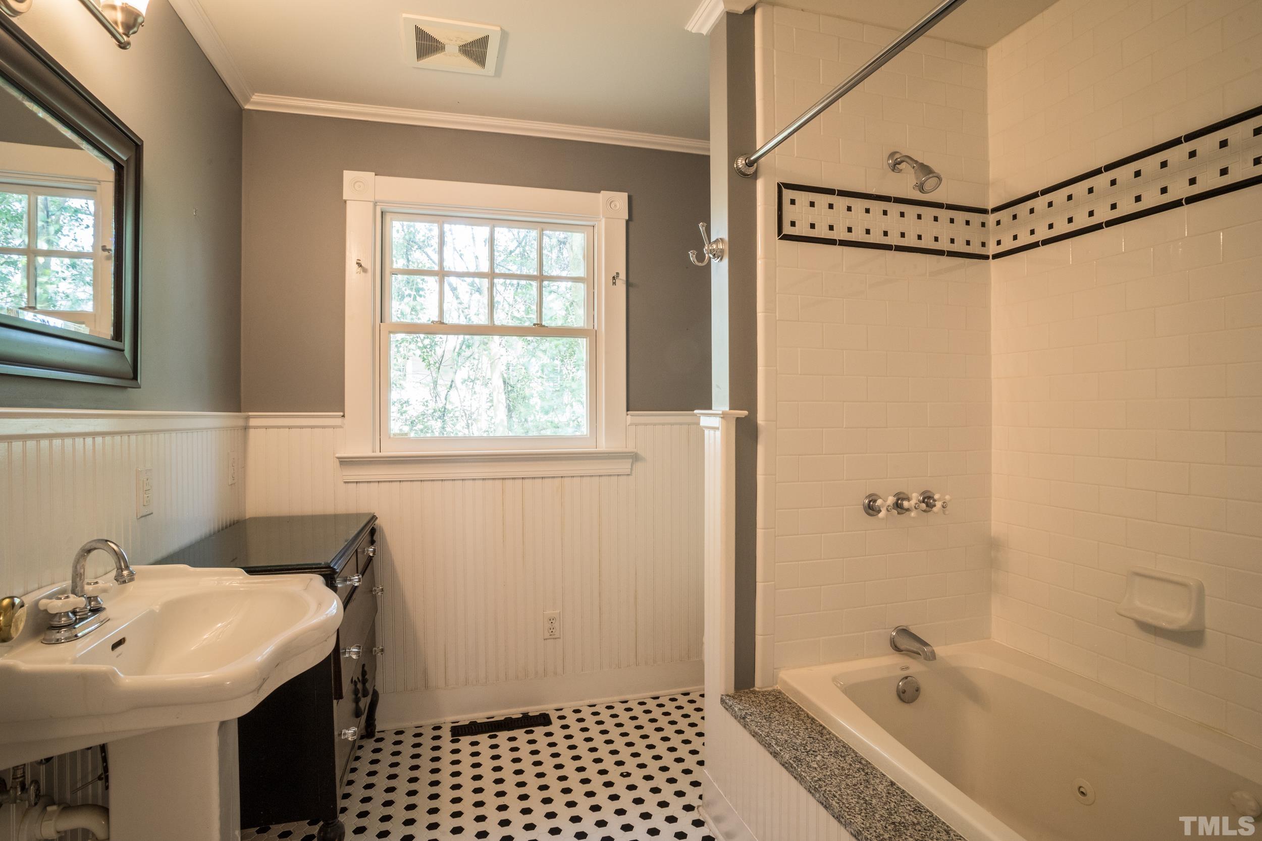 1903 Alexander Road Raleigh, NC 27608 - Photo 16 of 26 a bathroom with a sink a toilet and shower