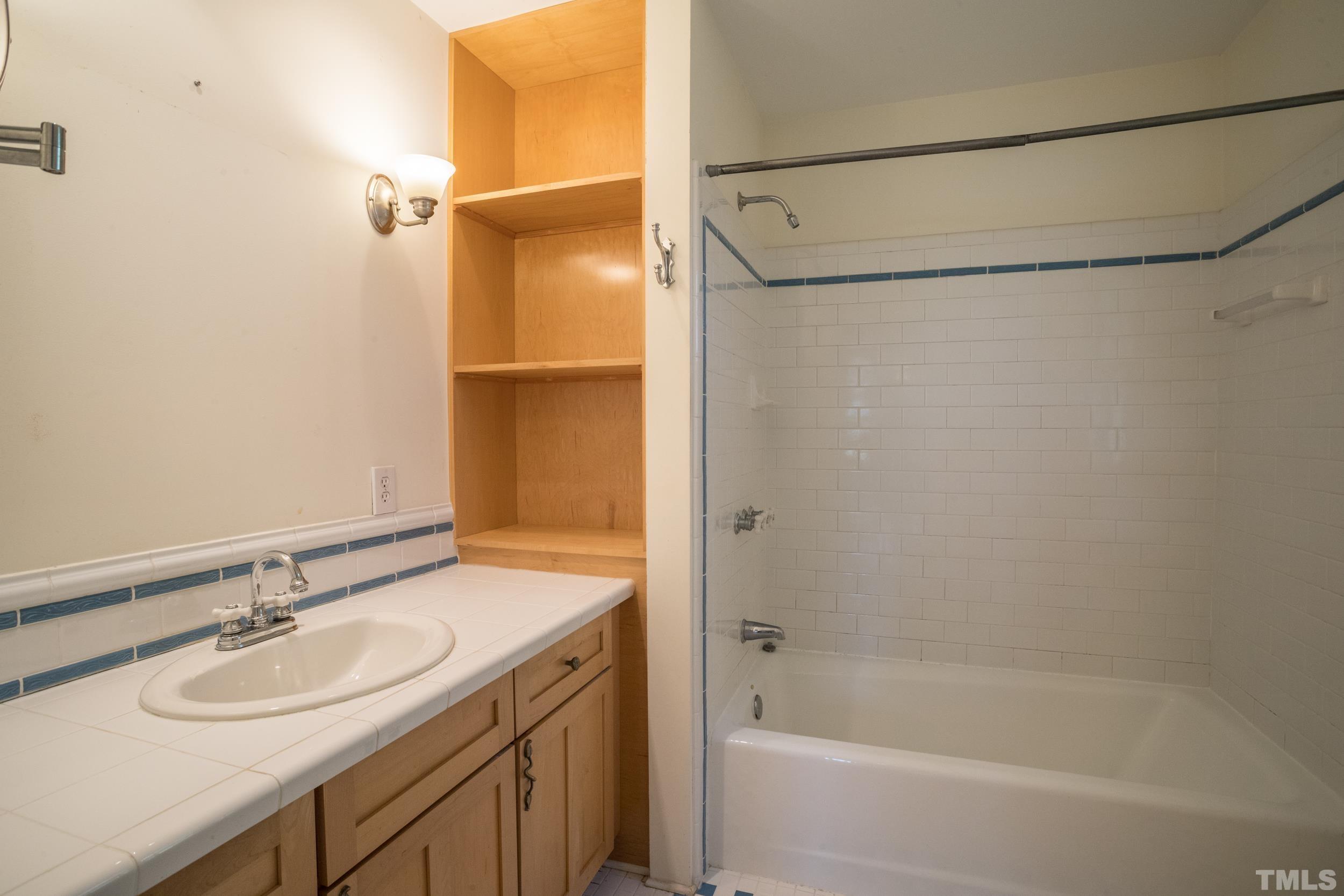 1903 Alexander Road Raleigh, NC 27608 - Photo 19 of 26 a bathroom with a sink and a mirror