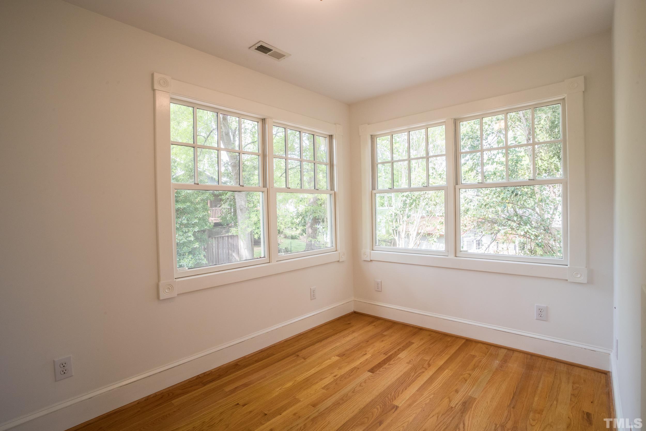 1903 Alexander Road Raleigh, NC 27608 - Photo 20 of 26 a view of an empty room with wooden floor and a window