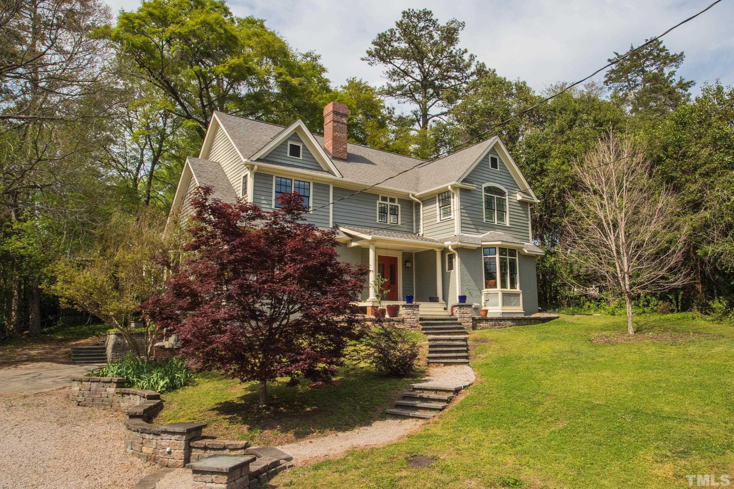 1903 Alexander Road Raleigh, NC 27608 - Photo 3 of 26 a front view of a house with a garden