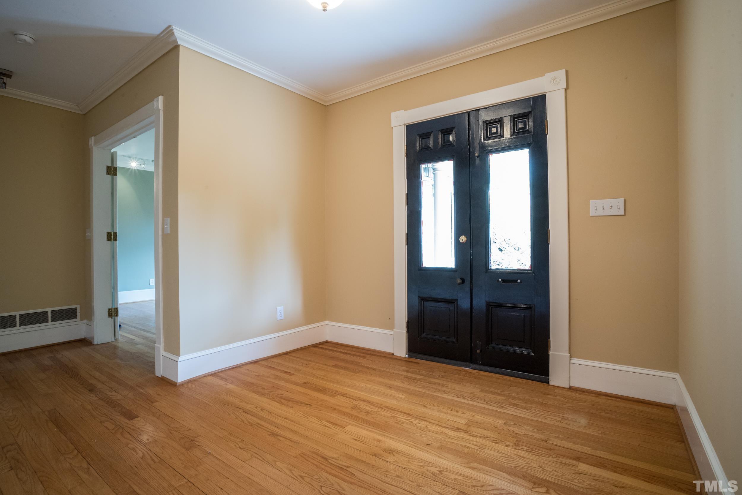 1903 Alexander Road Raleigh, NC 27608 - Photo 6 of 26 a view of an empty room with wooden floor and closet
