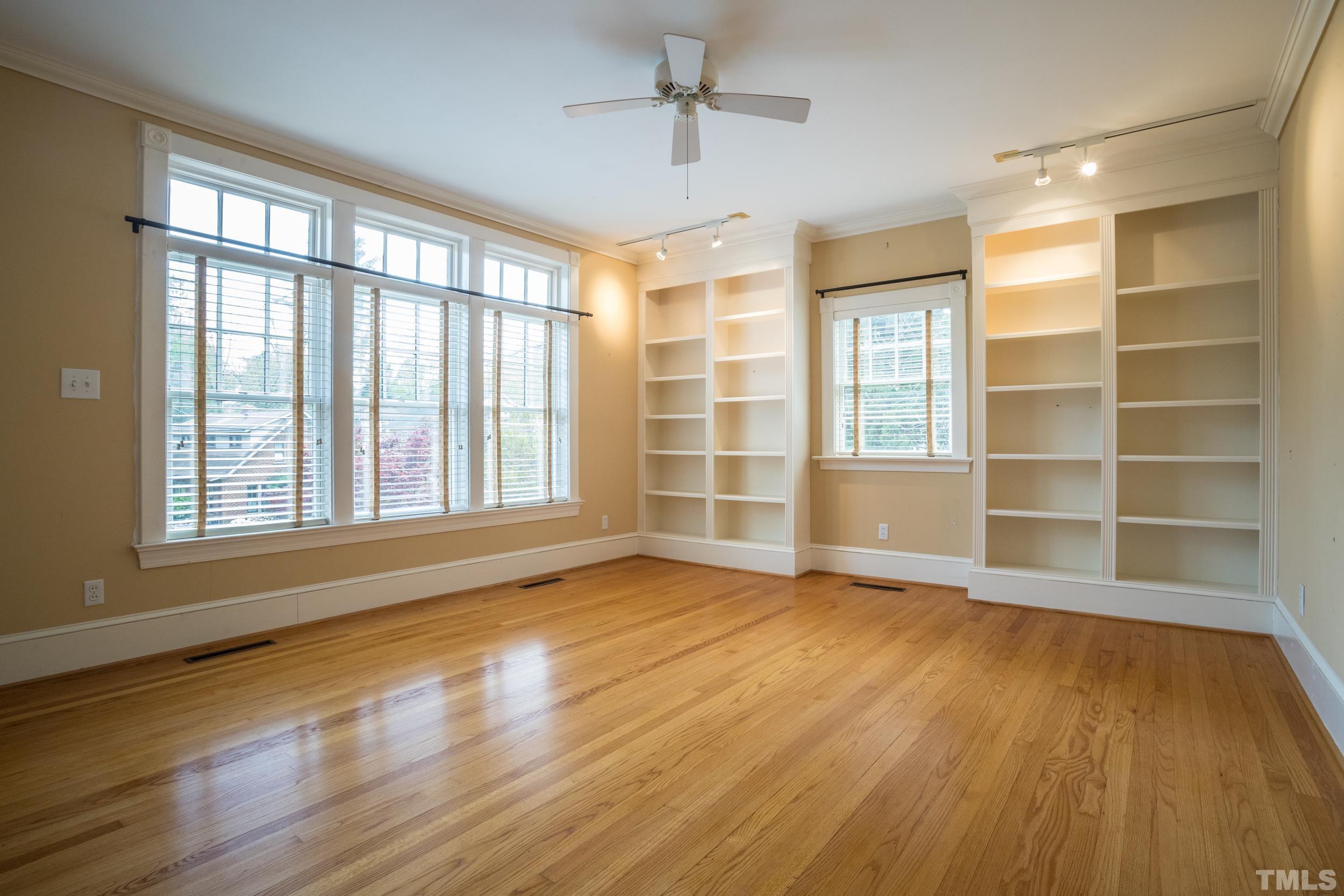 1903 Alexander Road Raleigh, NC 27608 - Photo 8 of 26 a view of an empty room with a window and wooden floor