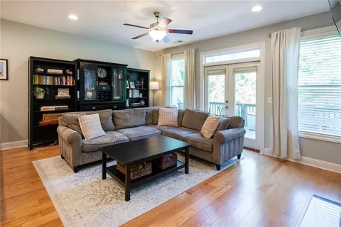 a living room with furniture a flat screen tv and a fireplace