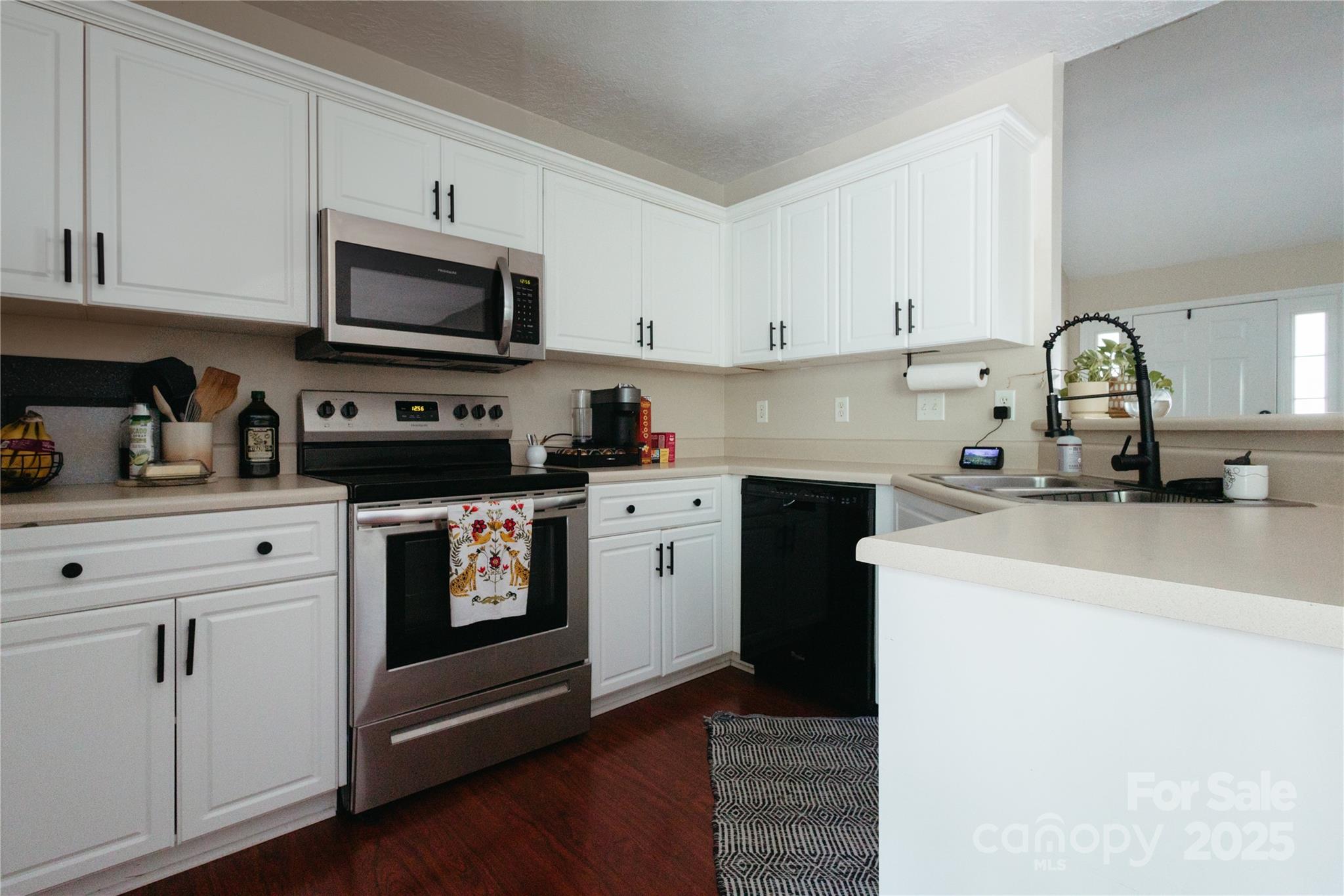 68 Lorry Court North Augusta, SC 29841 - Photo 4 of 16 a kitchen with white cabinets and black appliances