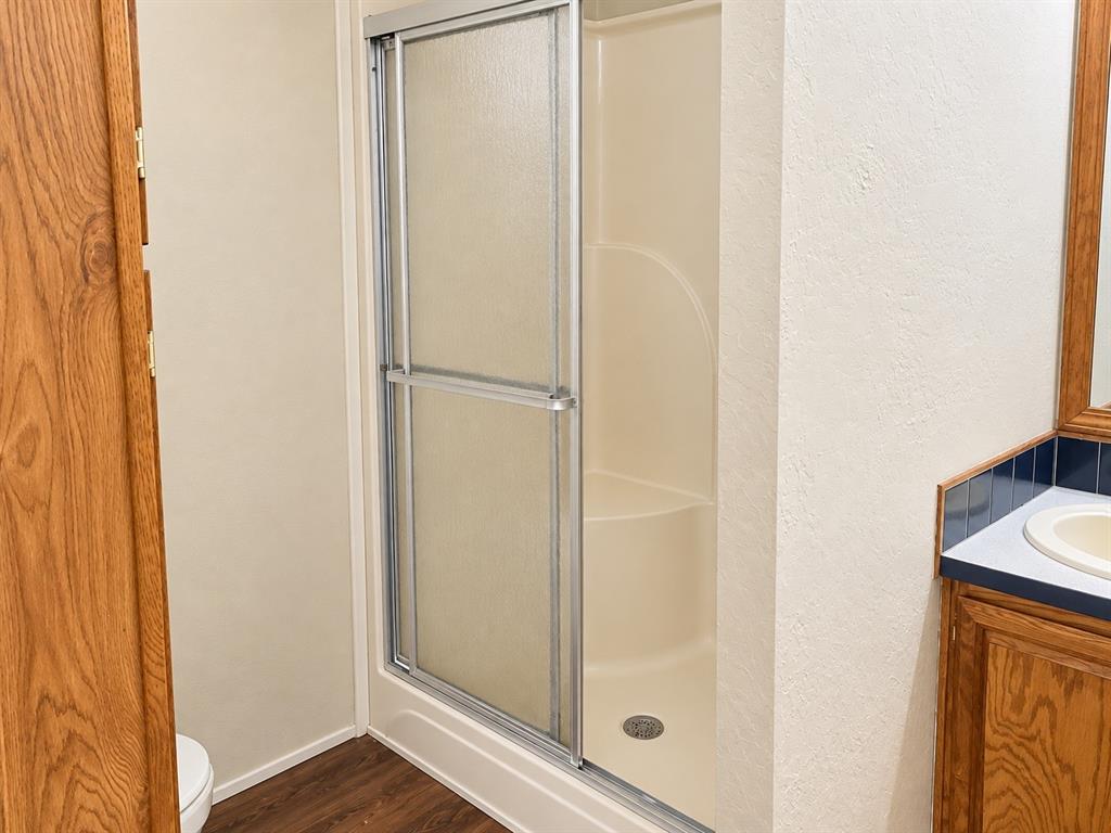 301 South Coppell Road, Unit 51 Coppell, TX 75019 - Photo 13 of 20 Enclosed shower with sliding glass doors