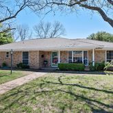 a front view of a house with a yard and porch