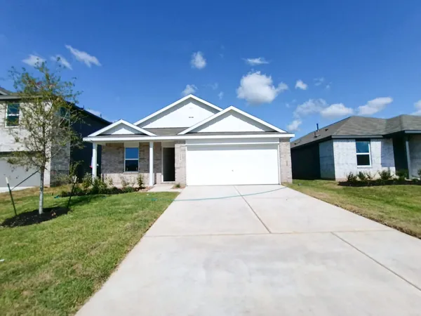 a front view of a house with a garden and yard