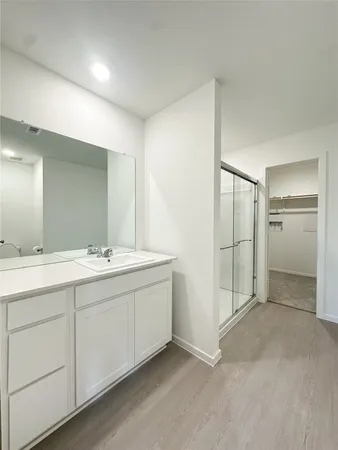 a bathroom with a double vanity sink and mirror