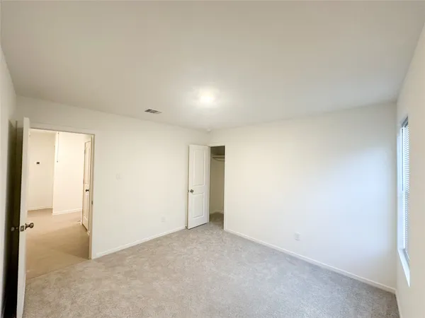 an empty room with closet area