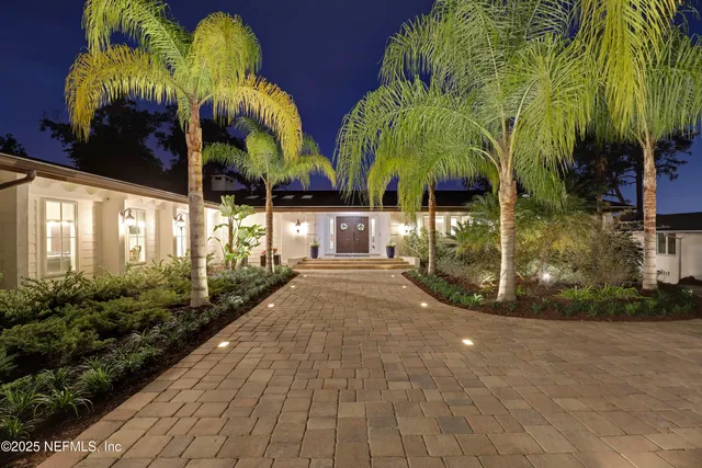 a bathroom with a double vanity sink a mirror and a shower