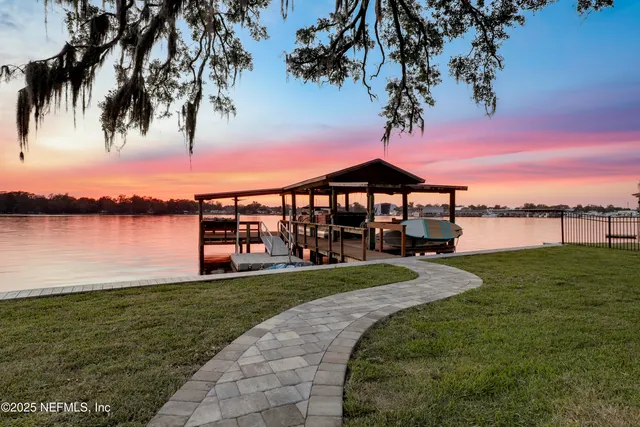 a spacious bathroom with a sink a shower and a mirror