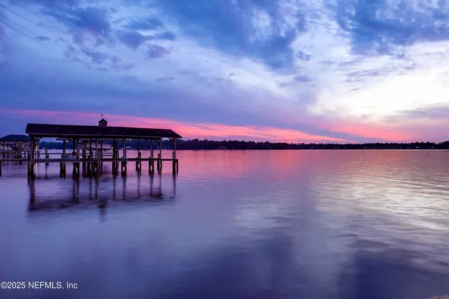 a view of a dining room with furniture wooden floor and a chandelier