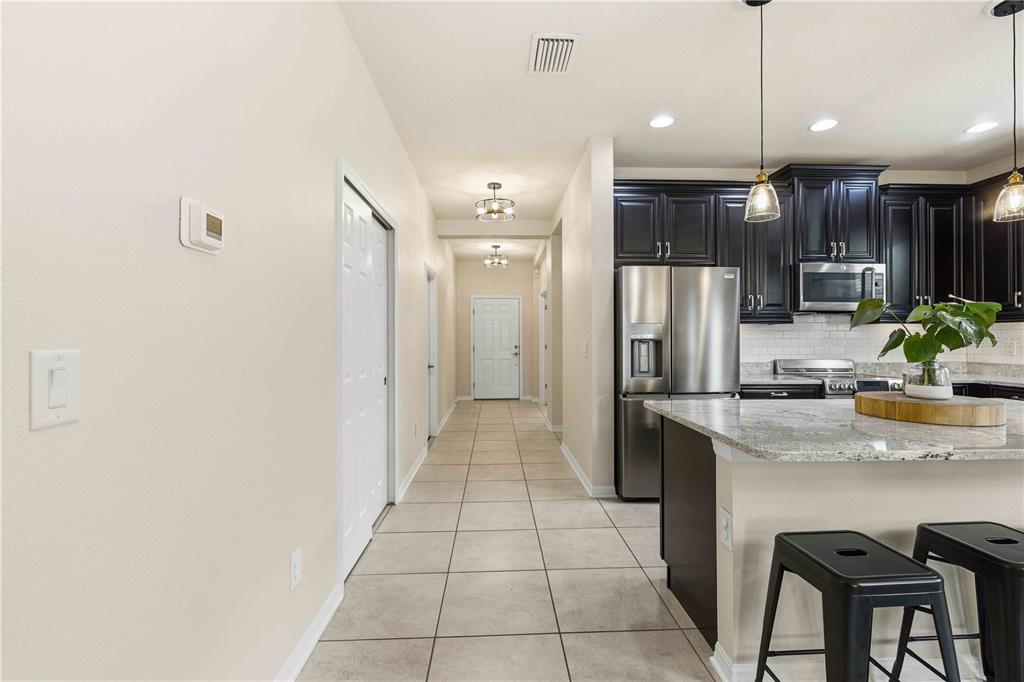 10920 79th Street East Parrish, FL 34219 - Photo 6 of 73 a kitchen with stainless steel appliances granite countertop a refrigerator a sink a stove and cabinets