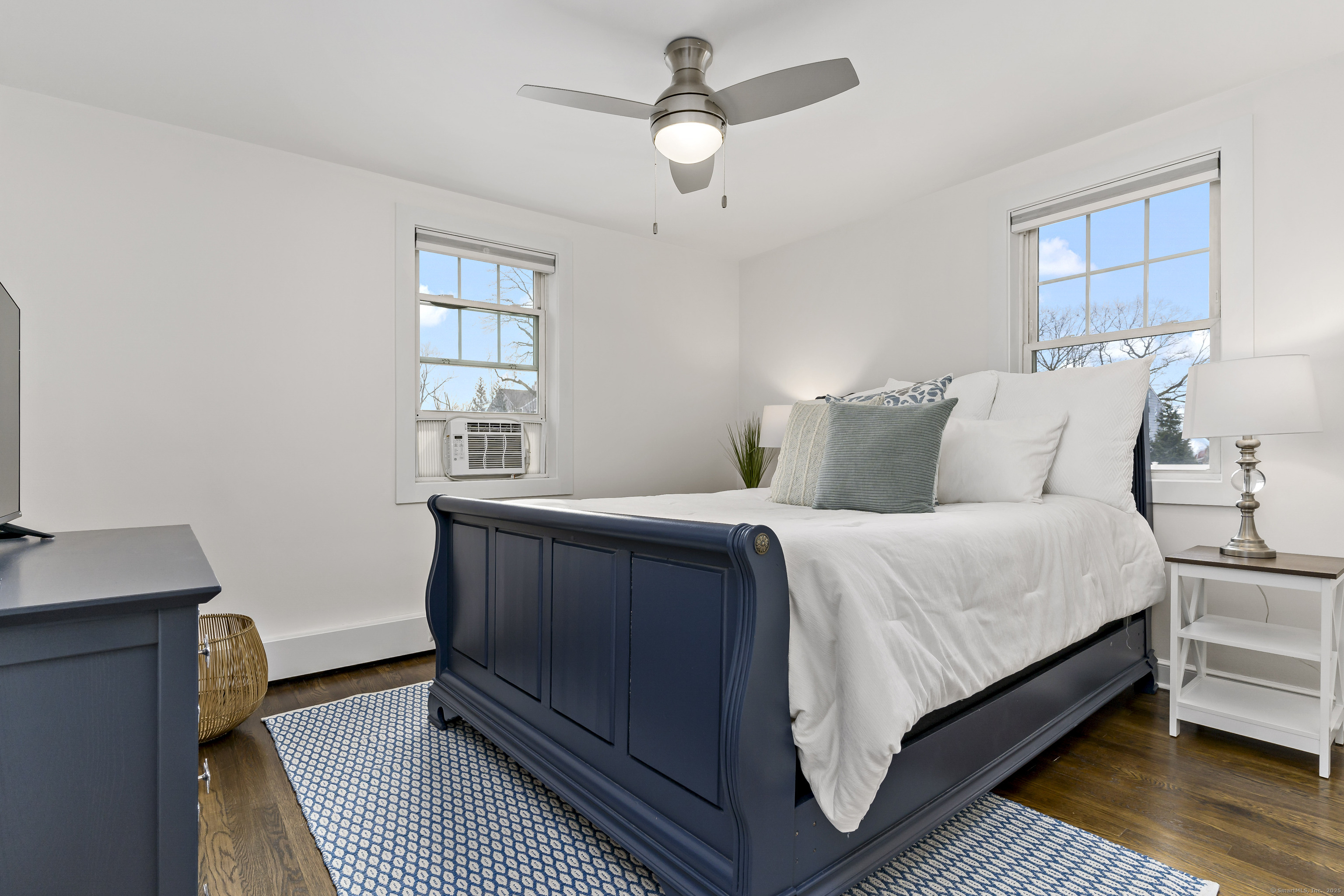 788 Reef Road Fairfield, CT 06824 - Photo 11 of 17 a bedroom with a bed wooden floor and window