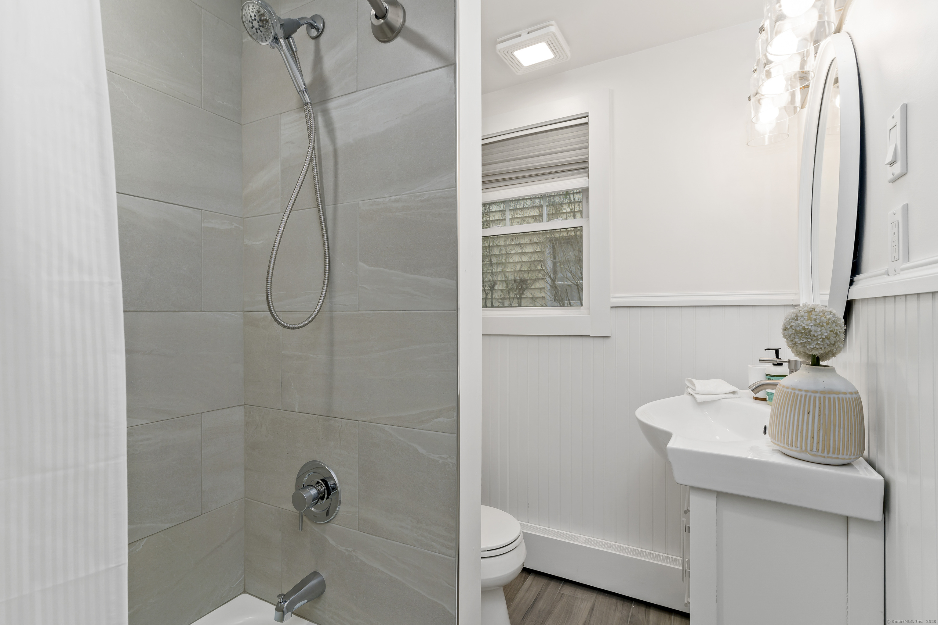 788 Reef Road Fairfield, CT 06824 - Photo 12 of 17 a bathroom with a sink a toilet and shower