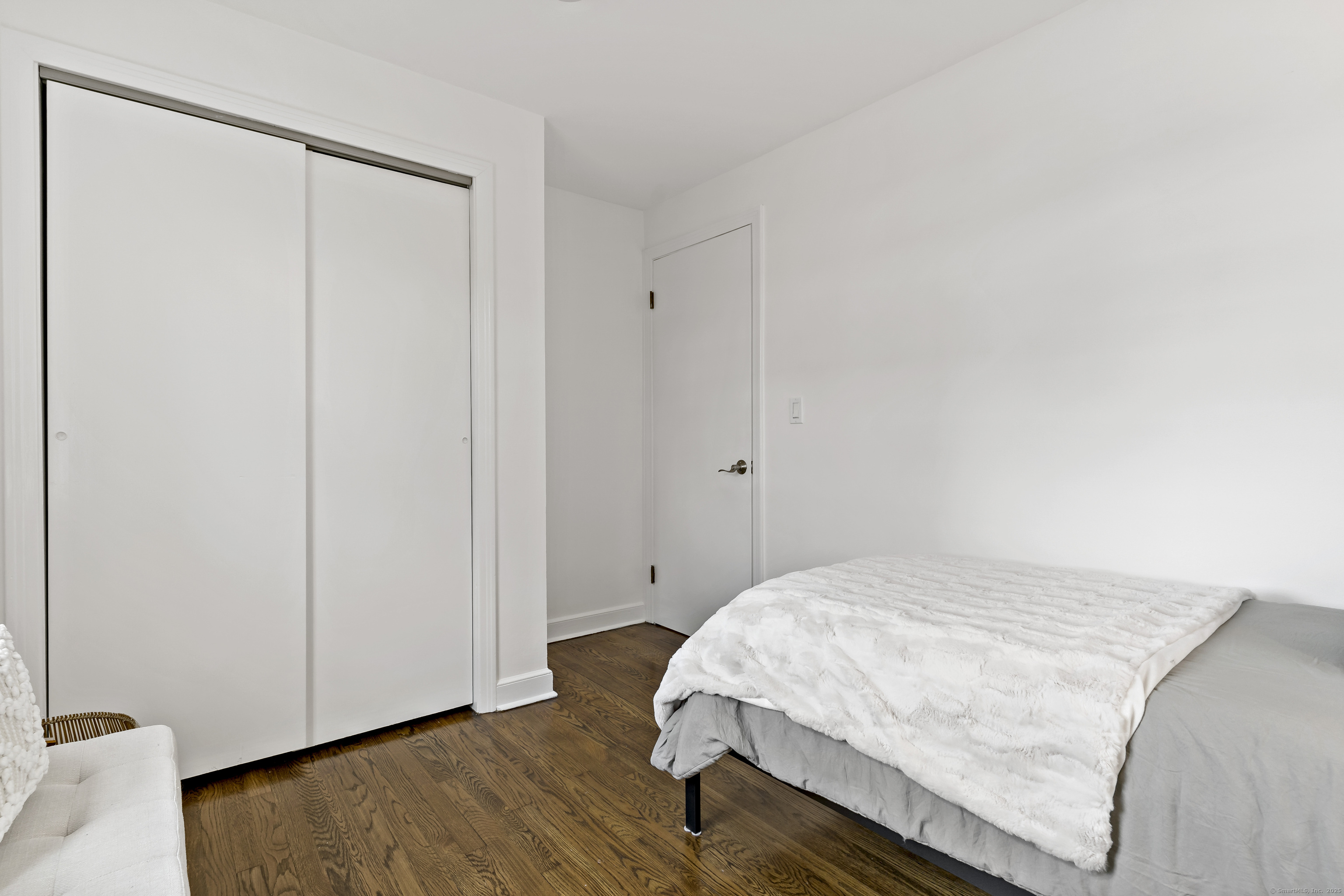 788 Reef Road Fairfield, CT 06824 - Photo 14 of 17 a bedroom with a bed and wooden floor