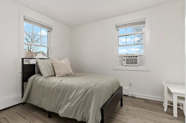 a bedroom with a bed and a window