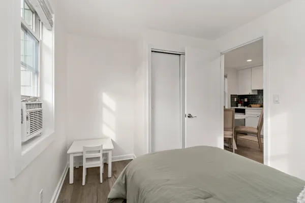 a bedroom with a bed and a chair in it