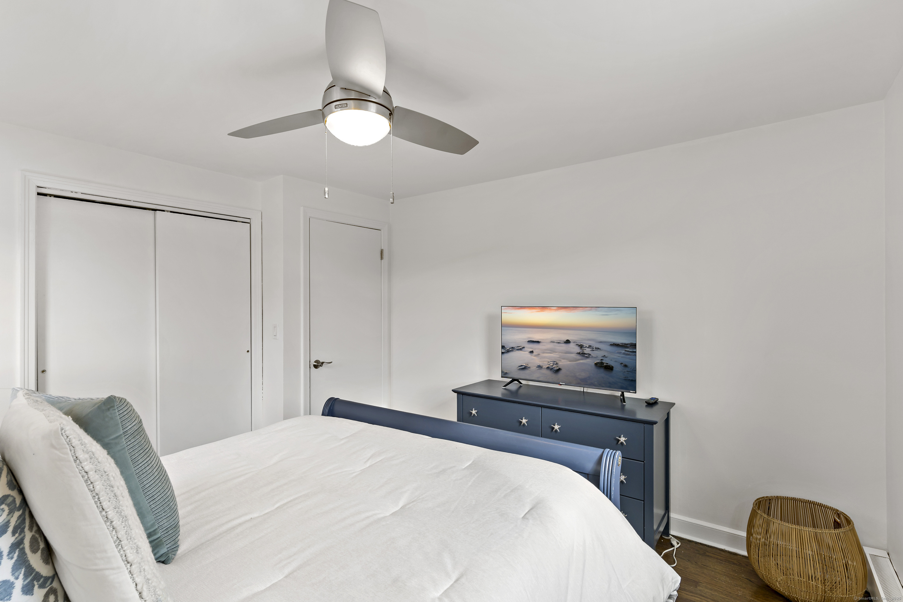 788 Reef Road Fairfield, CT 06824 - Photo 3 of 17 a bedroom with a bed and a lamp