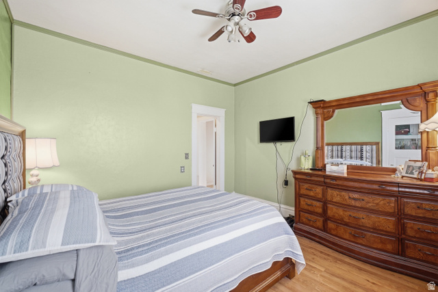 5264 West 5500th Street South Hooper, UT 84315 - Photo 20 of 38 Room featuring light green walls with a darker green crown molding, wood-finish flooring, and a ceiling fan