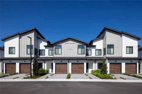 a front view of a house with garage and traffic signal