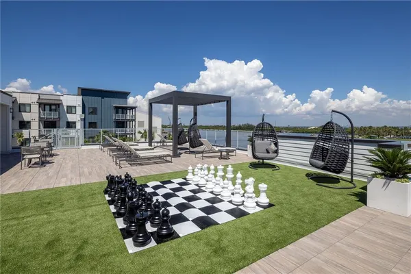 a view of a house with a yard and palm trees