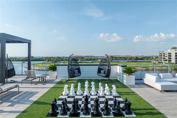 a view of a ocean with boats and trees in the background