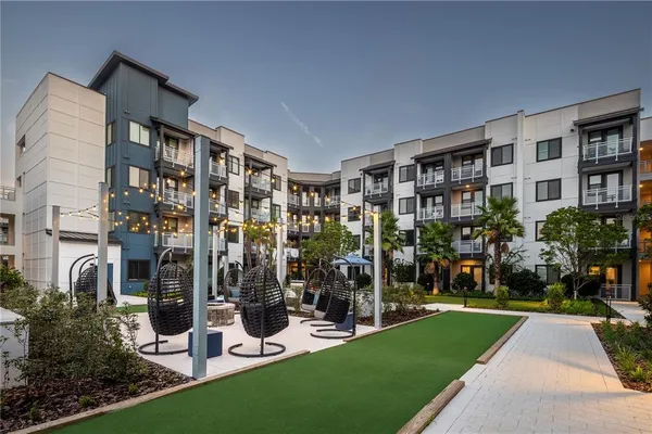 a living room with furniture and a painting on the wall