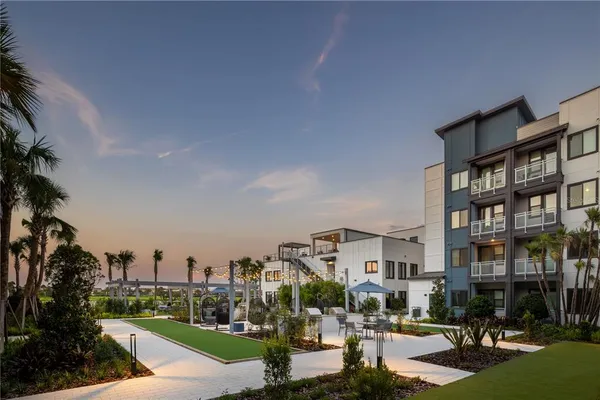 a living room with furniture and a floor to ceiling window
