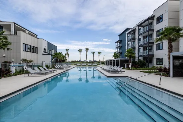 a view of a swimming pool with outdoor seating