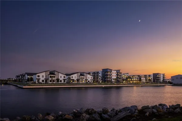 a room with lots of white furniture and a window