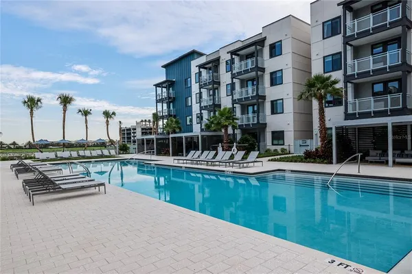 a view of building with swimming pool and sitting area