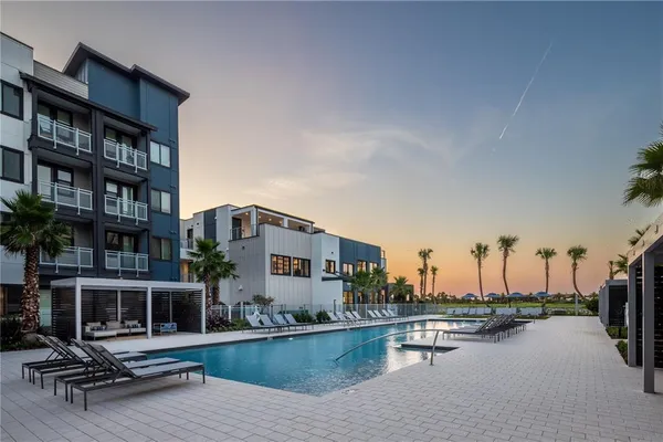 a view of swimming pool with outdoor seating and plants