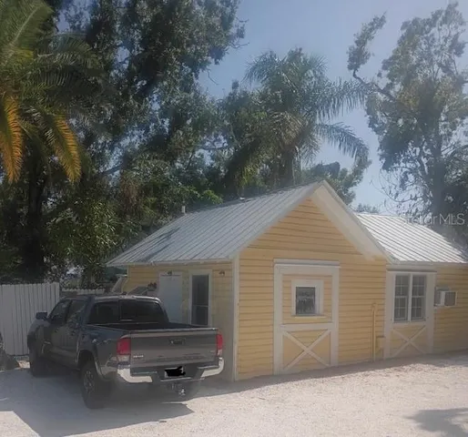 a backyard of a house with car parked