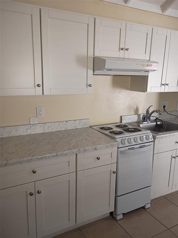 1622 9th Street, Unit B Sarasota, FL 34236 - Photo 2 of 15 a kitchen with granite countertop white cabinets and white appliances