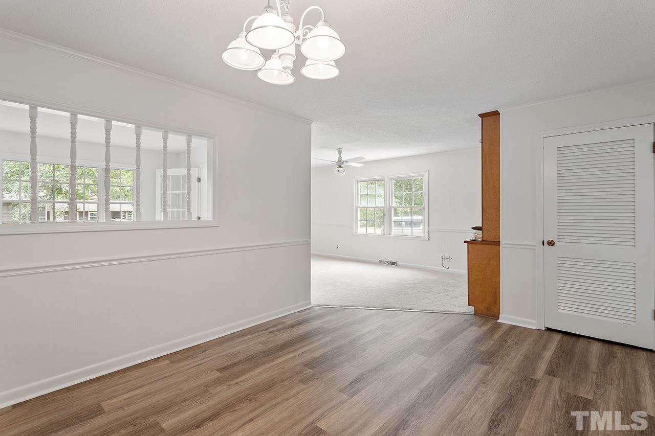 6407 Amhurst Road Durham, NC 27713 - Photo 13 of 28 an empty room with wooden floor and windows