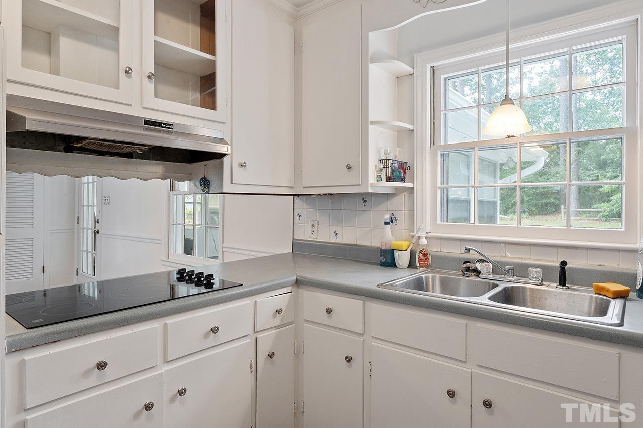 6407 Amhurst Road Durham, NC 27713 - Photo 17 of 28 a kitchen with stainless steel appliances a sink and cabinets