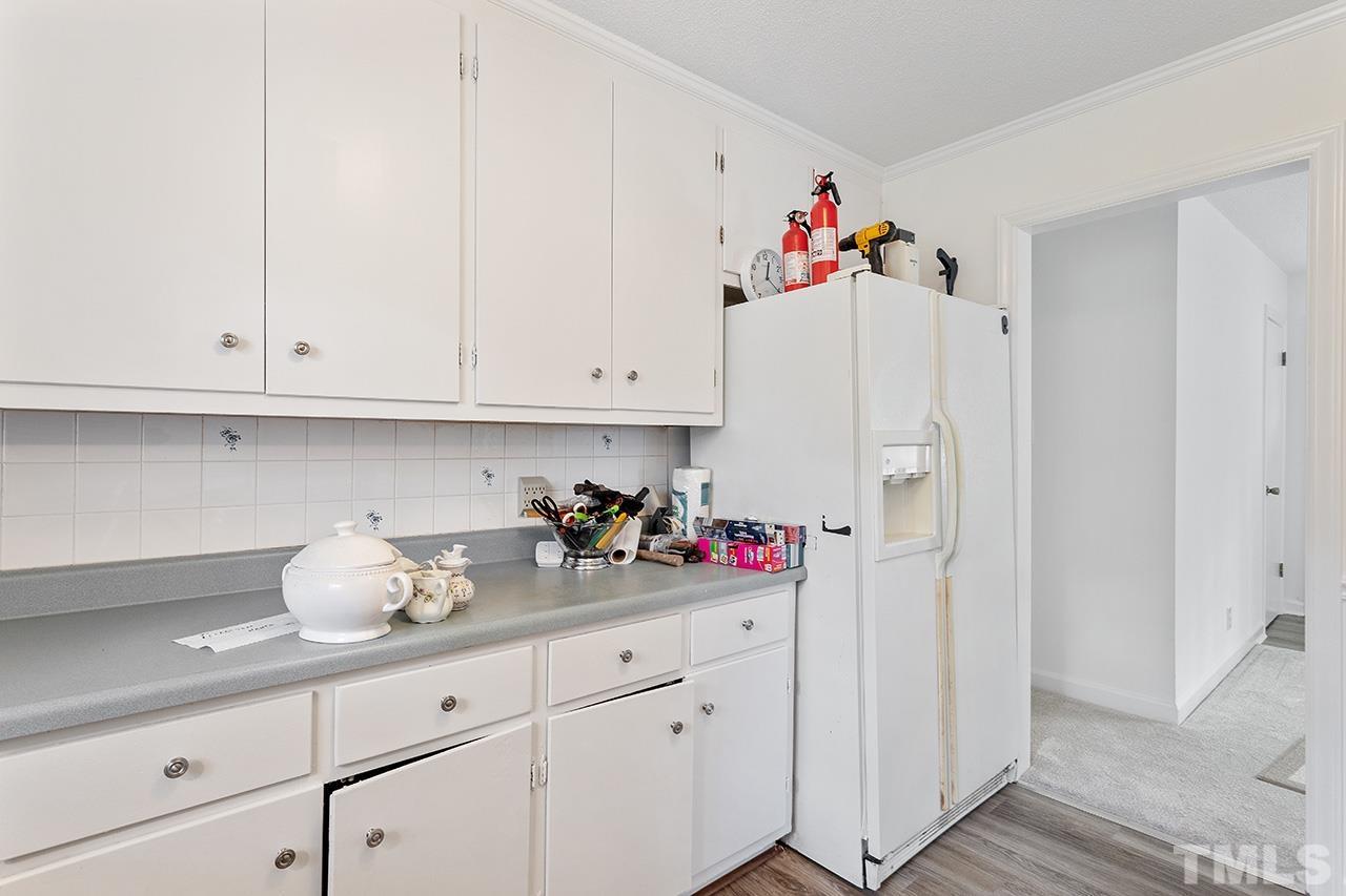 6407 Amhurst Road Durham, NC 27713 - Photo 18 of 28 a kitchen with white cabinets and white appliances