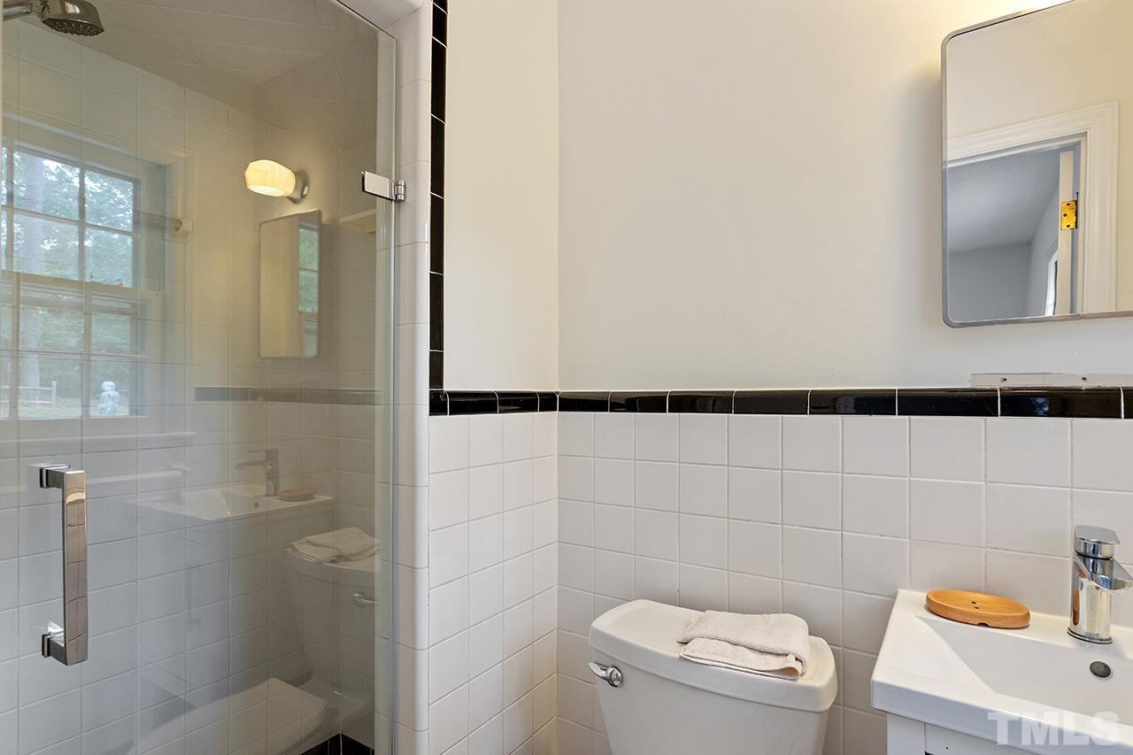 6407 Amhurst Road Durham, NC 27713 - Photo 23 of 28 a bathroom with a toilet and a shower