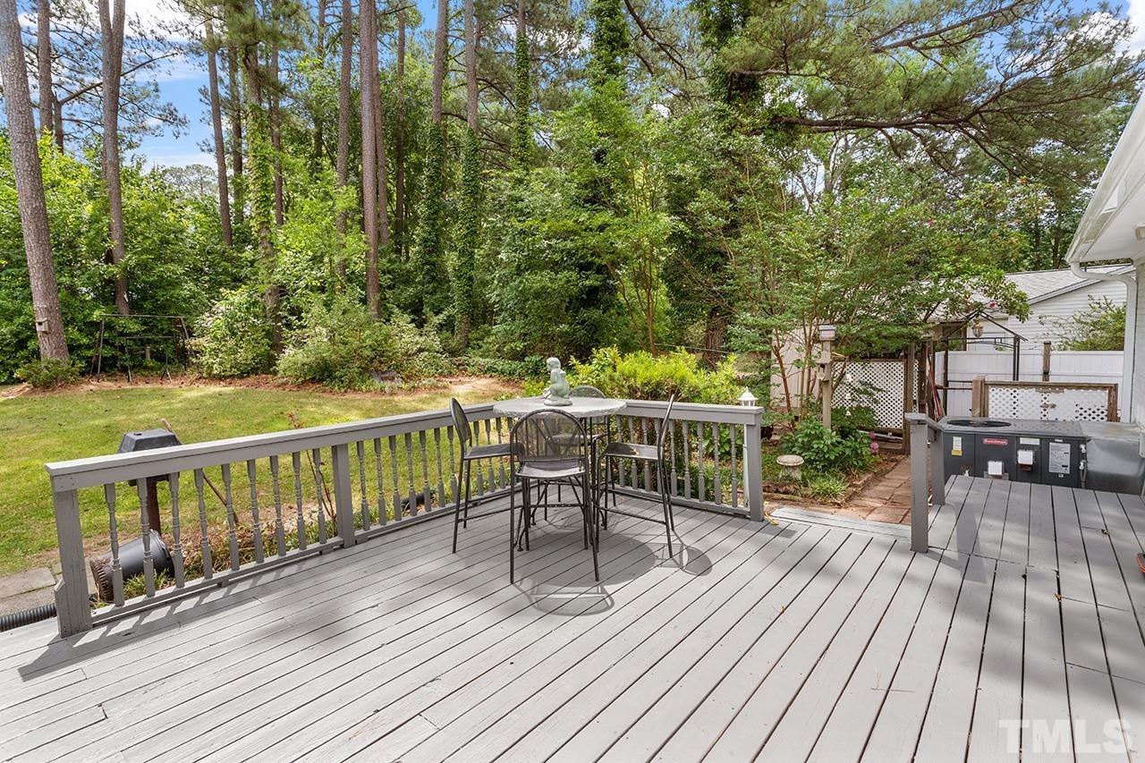 6407 Amhurst Road Durham, NC 27713 - Photo 26 of 28 a view of a deck with furniture and trees