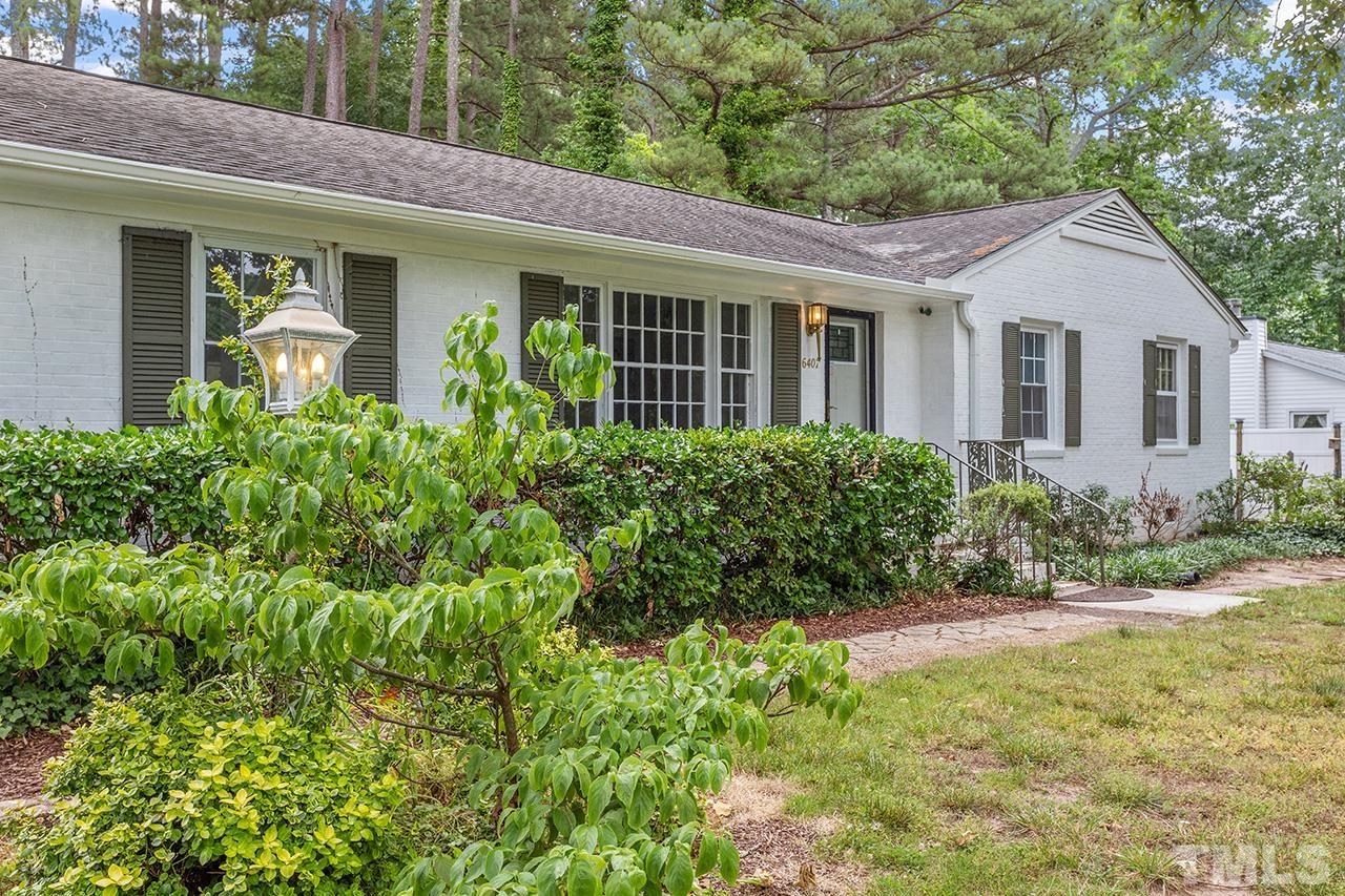 6407 Amhurst Road Durham, NC 27713 - Photo 3 of 28 a view of a house with brick walls and a yard with plants