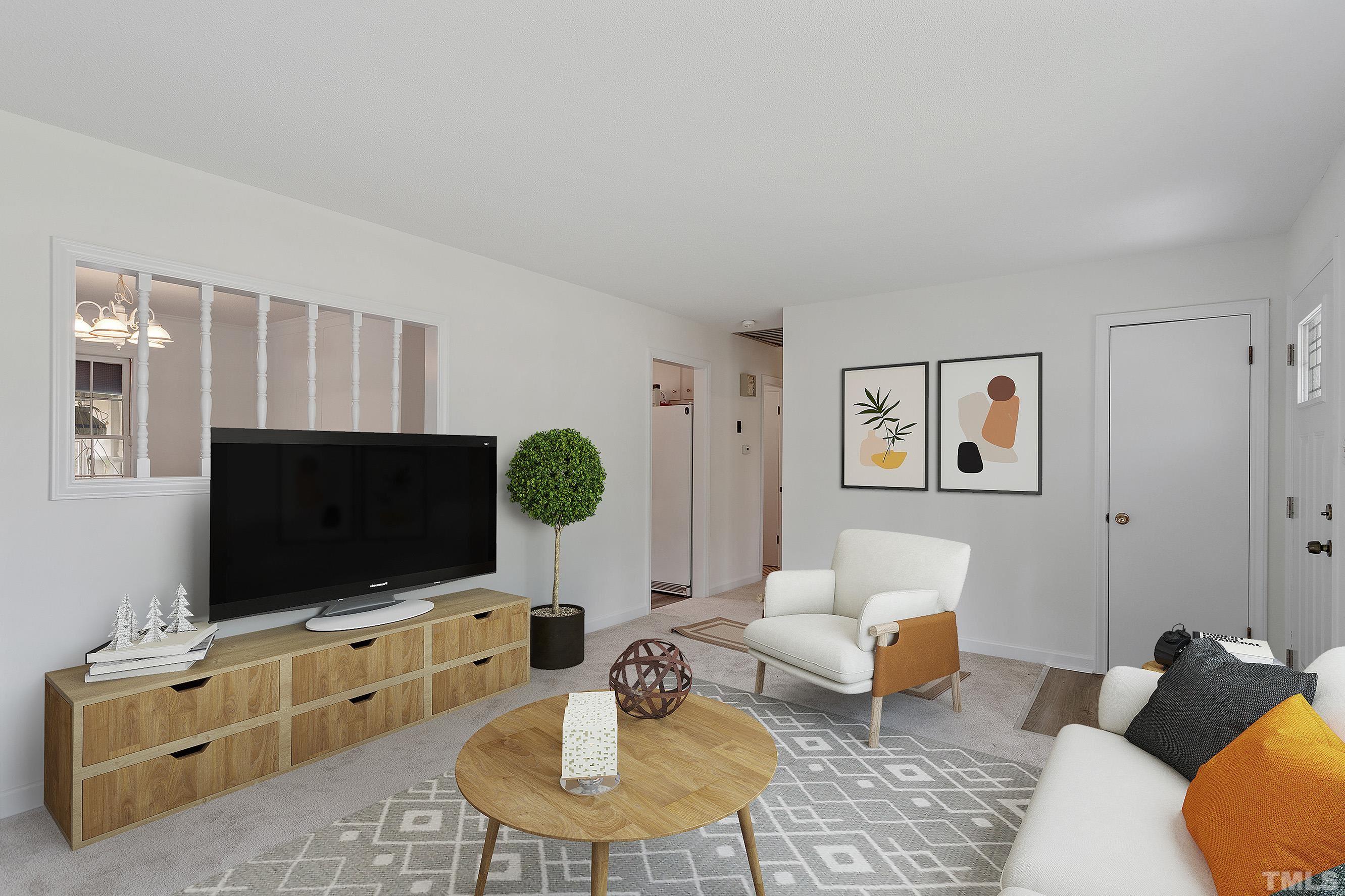 6407 Amhurst Road Durham, NC 27713 - Photo 4 of 28 a living room with furniture and a flat screen tv