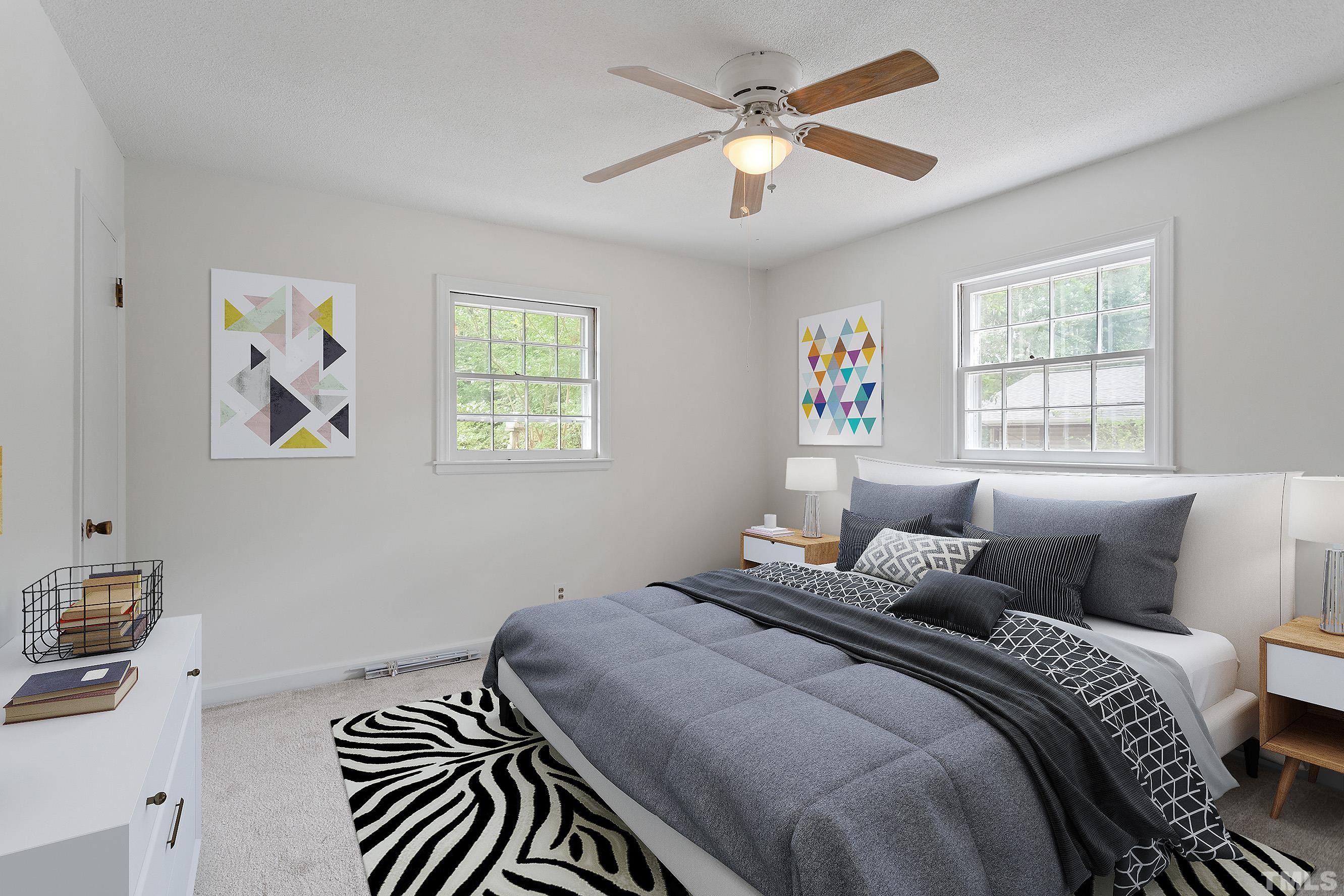 6407 Amhurst Road Durham, NC 27713 - Photo 6 of 28 a bedroom with a bed and a chandelier