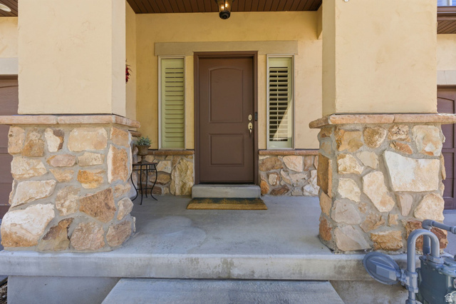7235 Viansa Court Midvale, UT 84047 - Photo 40 of 43 Doorway to property featuring stone siding and stucco siding